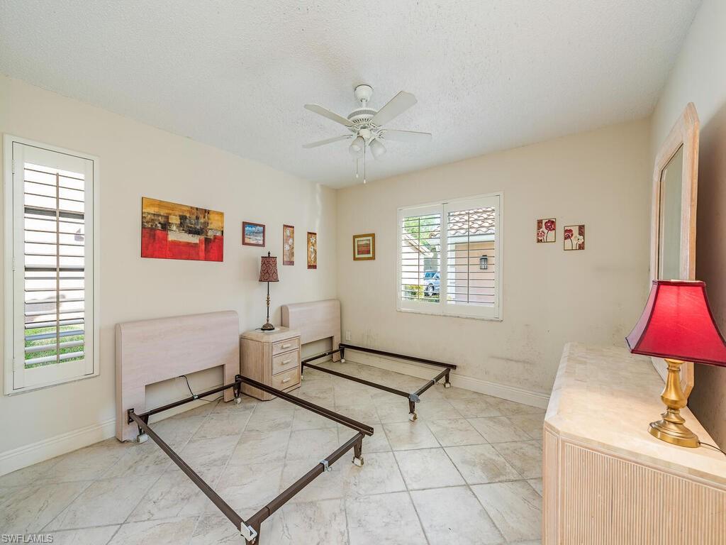 5920 Cranbrook Way, Unit F106 Naples, FL 34112 - Photo 9 of 12 a living room with furniture and a window