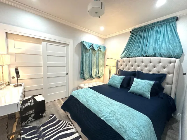 a bedroom with a bed and a window