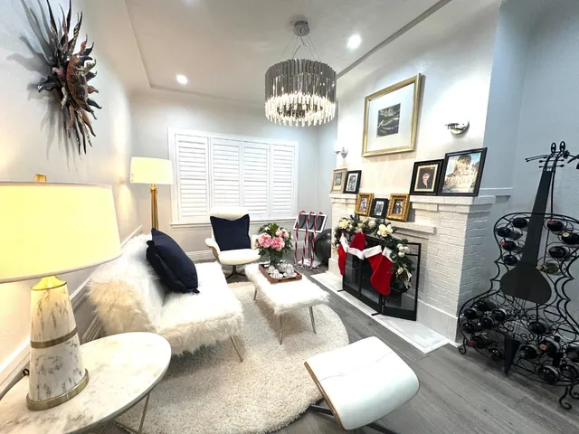 a living room with furniture and a chandelier