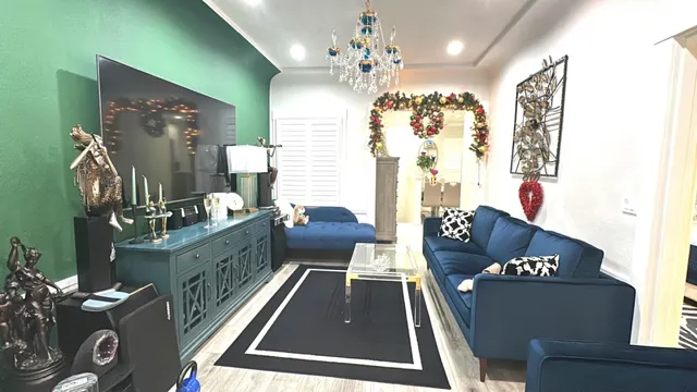 a living room with furniture and a chandelier