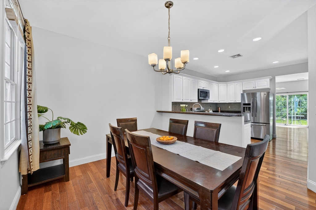 15 Evergreen Circle, Unit 15 Canton, MA 02021 - Photo 13 of 29 a kitchen with stainless steel appliances granite countertop a dining table chairs stove and refrigerator