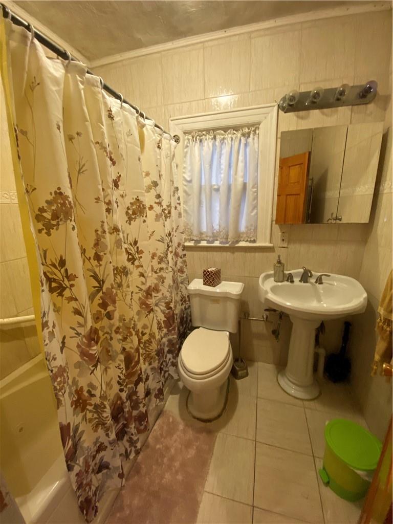 4058 Bronx Boulevard Bronx, NY 10466 - Photo 16 of 19 a bathroom with a sink toilet and shower