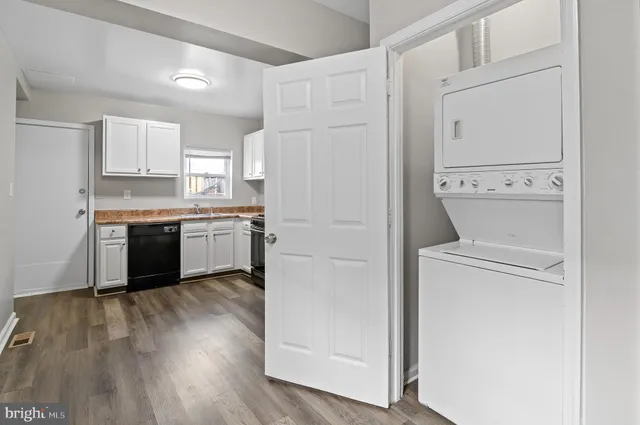 a kitchen with cabinets a sink and white stainless steel appliances