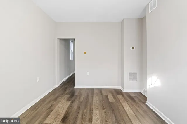 a view of a room with wooden floor