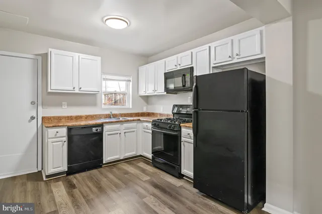 a kitchen with a refrigerator stove and microwave
