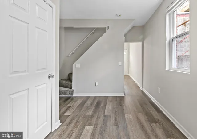 wooden floor in an empty room with a window