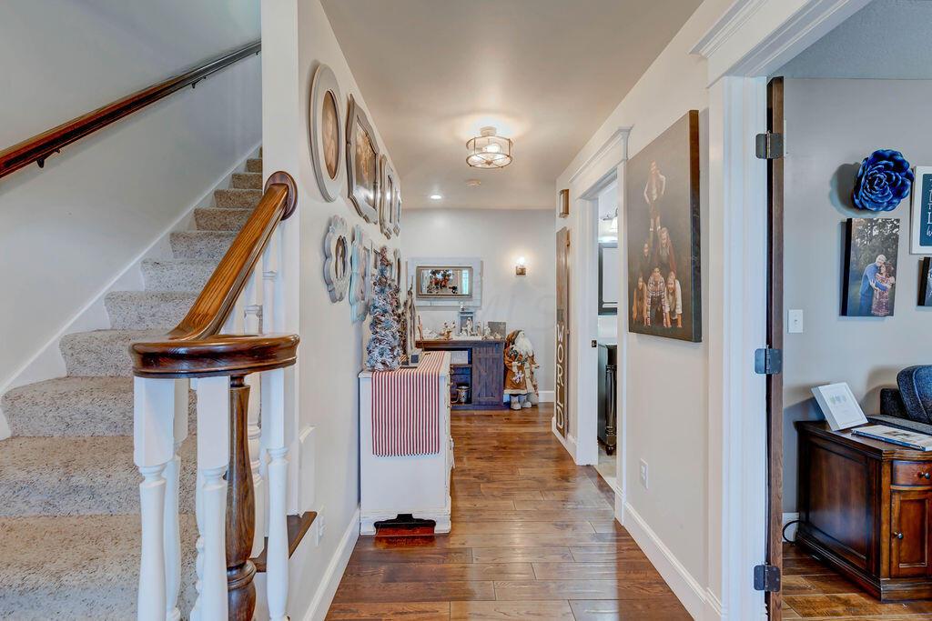4045 Russell Road Mount Gilead, OH 43338 - Photo 3 of 74 • Hardwood flooring • Tan painted walls • Two ceiling lights • Extra wide hallways/doorway for wheelchair • Den to right