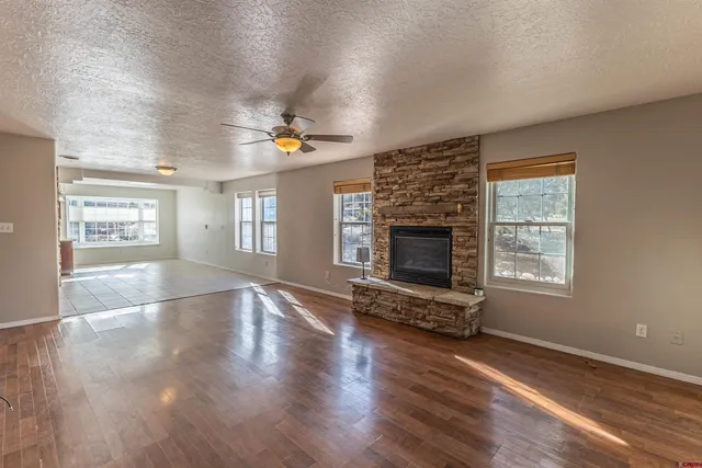 an empty room with windows fireplace and windows
