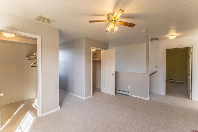 a view of a hallway with wooden shelves
