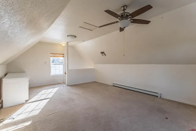 a bedroom with a bed and a night stand