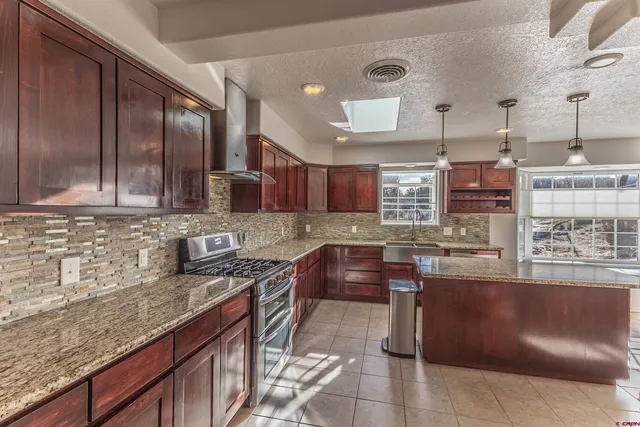 a kitchen with stainless steel appliances granite countertop a sink and cabinets
