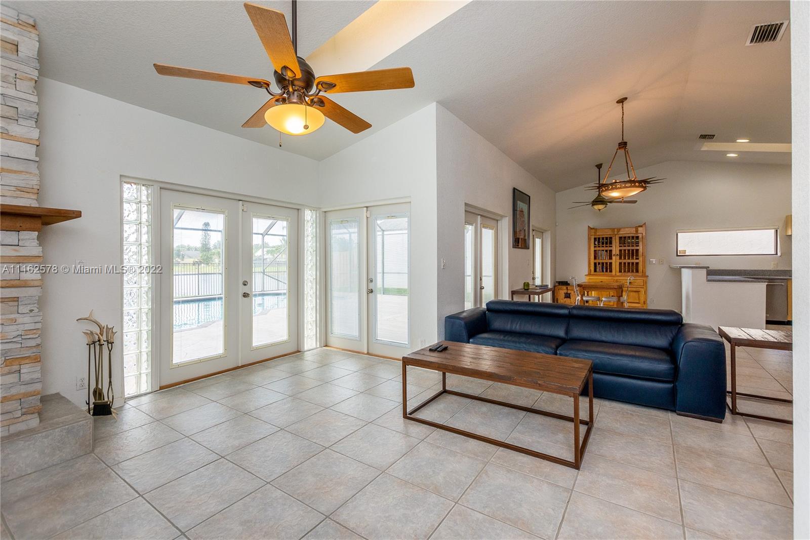11612 Quiet Waters Lane Boca Raton, FL 33428 - Photo 13 of 70 a living room with furniture and a chandelier