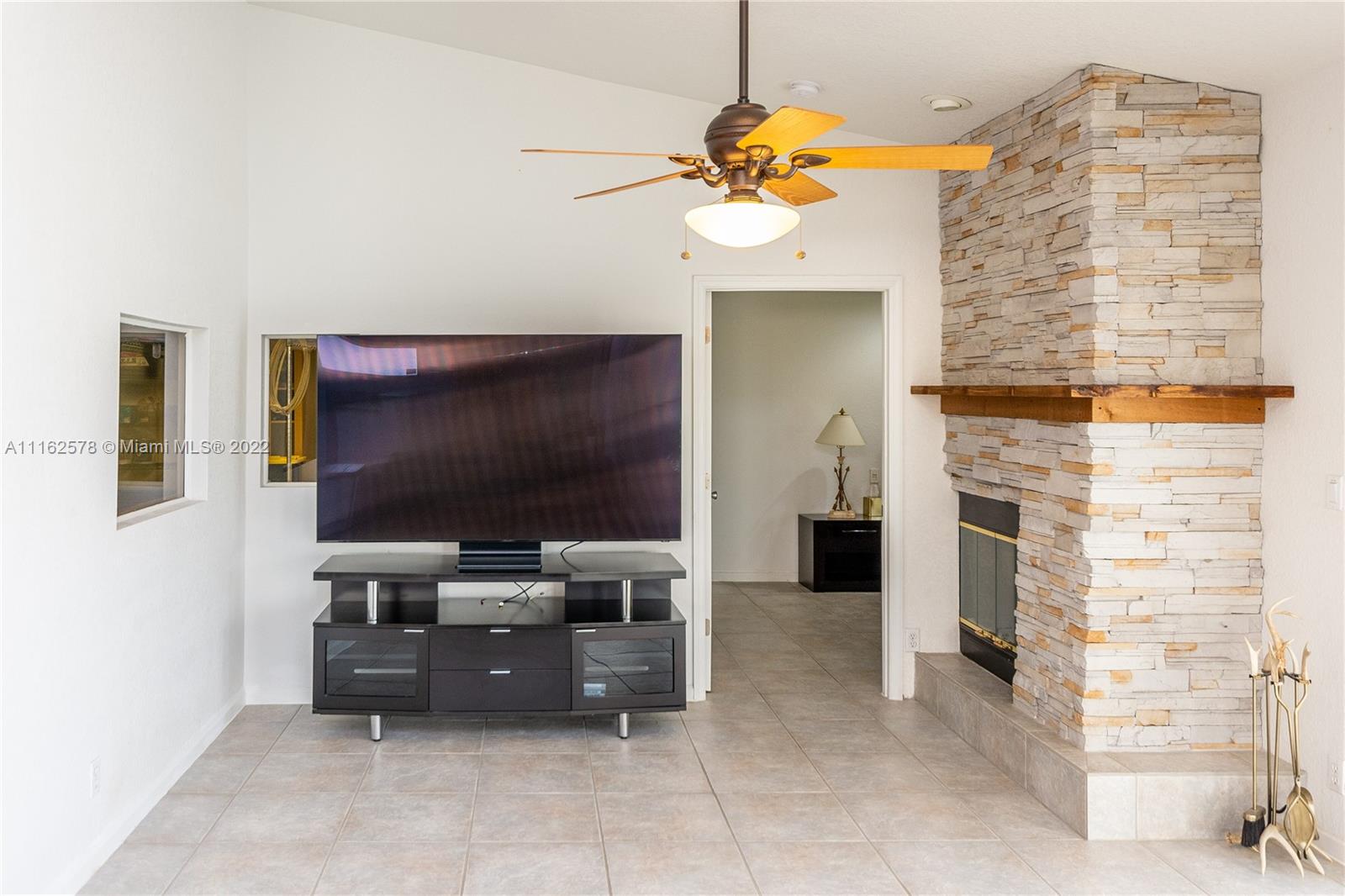 11612 Quiet Waters Lane Boca Raton, FL 33428 - Photo 18 of 70 a living room with furniture and a flat screen tv