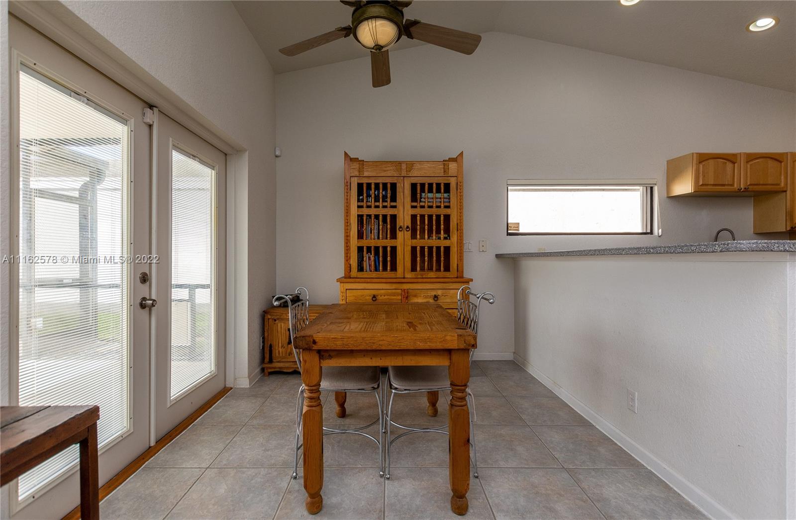 11612 Quiet Waters Lane Boca Raton, FL 33428 - Photo 21 of 70 a dining room with furniture and window