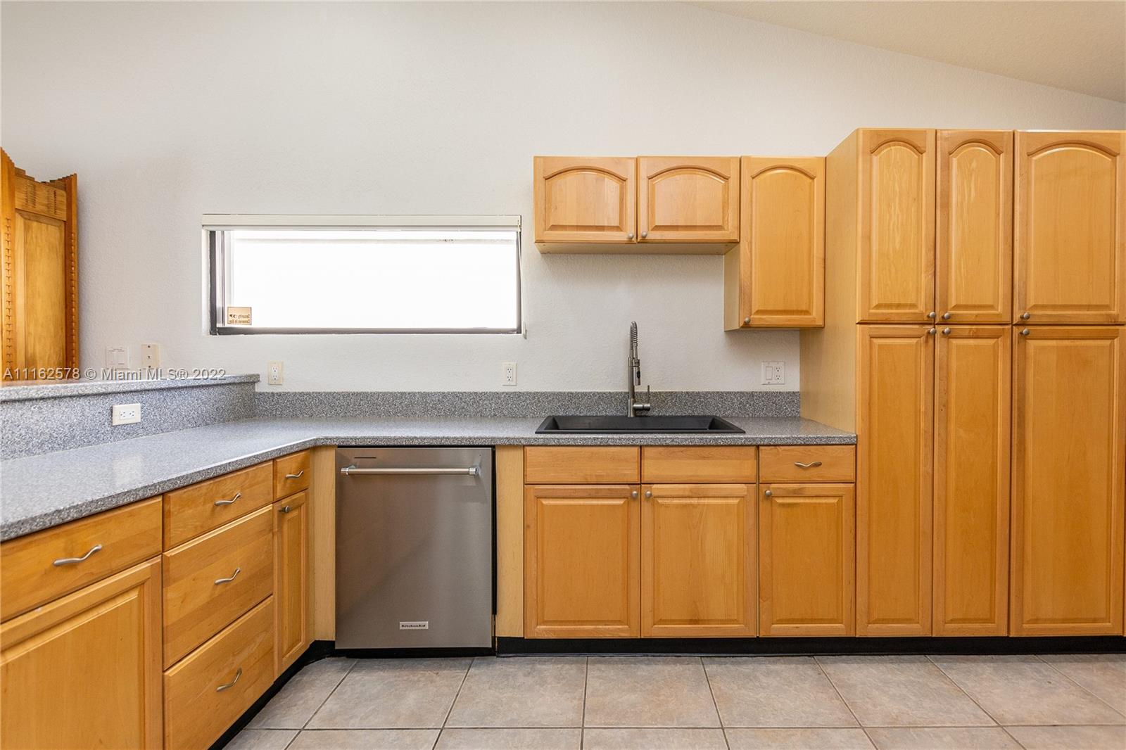 11612 Quiet Waters Lane Boca Raton, FL 33428 - Photo 28 of 70 a kitchen with stainless steel appliances granite countertop a sink and cabinets