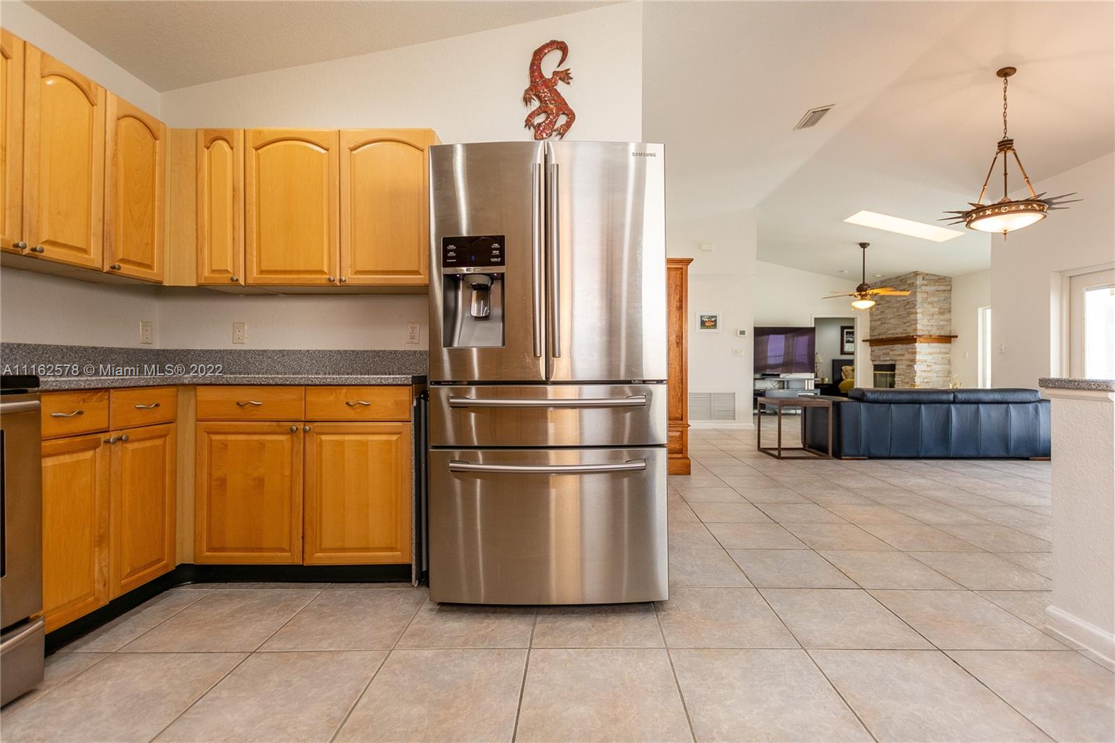 11612 Quiet Waters Lane Boca Raton, FL 33428 - Photo 30 of 70 a kitchen with stainless steel appliances granite countertop a refrigerator a sink a microwave and cabinets