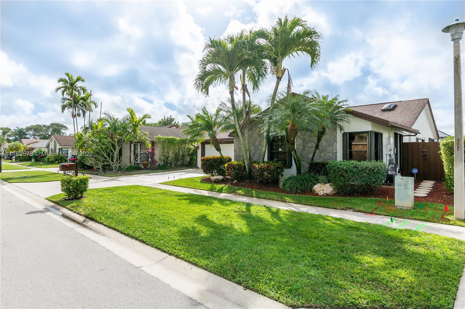 11612 Quiet Waters Lane Boca Raton, FL 33428 - Photo 3 of 70 a view of a backyard with a garden and plants