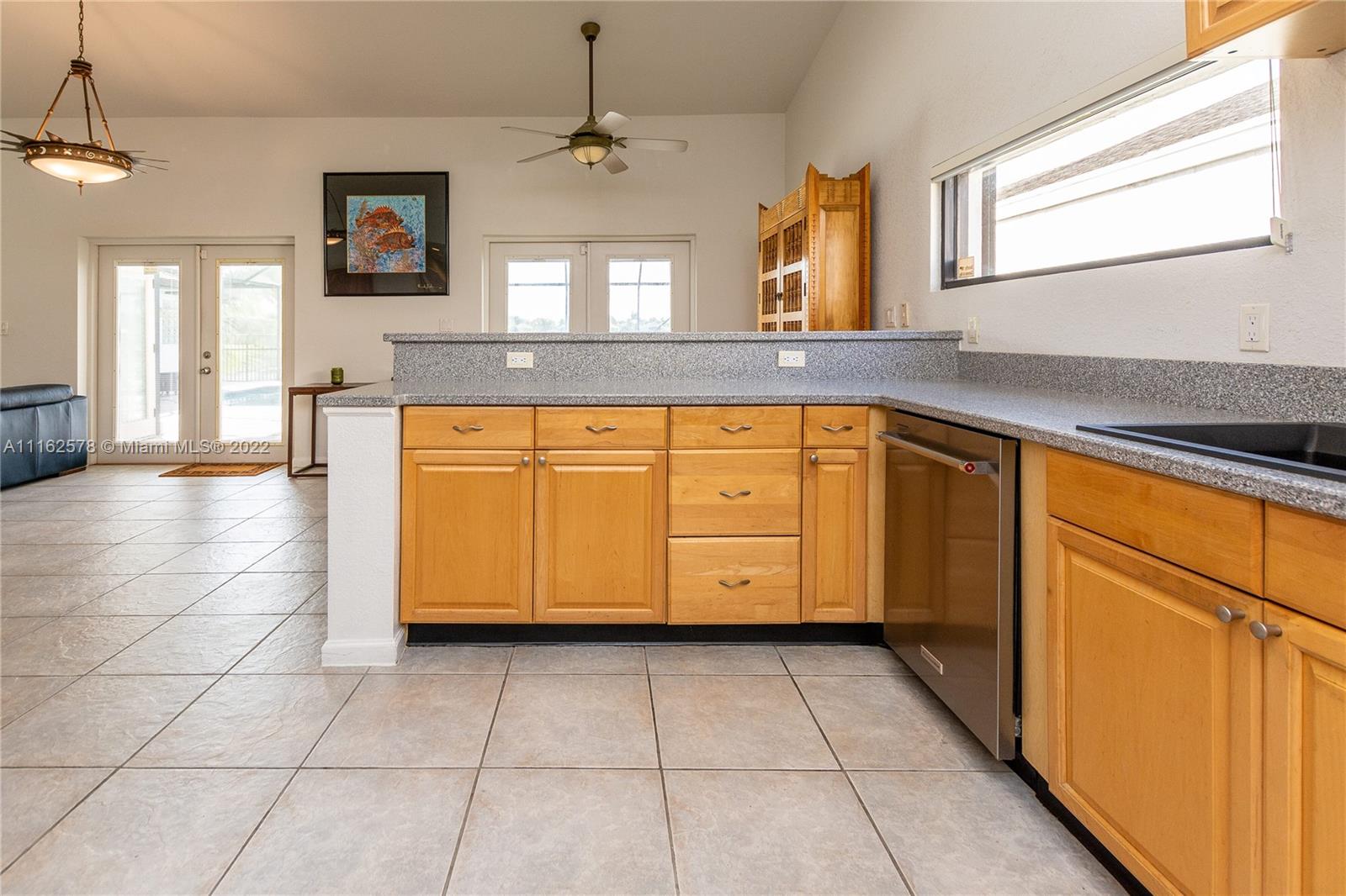 11612 Quiet Waters Lane Boca Raton, FL 33428 - Photo 32 of 70 a kitchen with stainless steel appliances granite countertop a sink and a cabinets