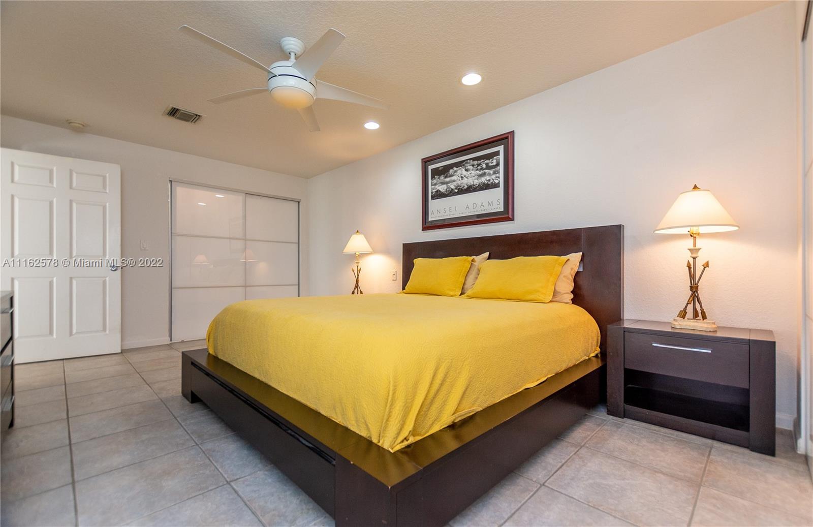 11612 Quiet Waters Lane Boca Raton, FL 33428 - Photo 34 of 70 a bedroom with a bed and a lamp
