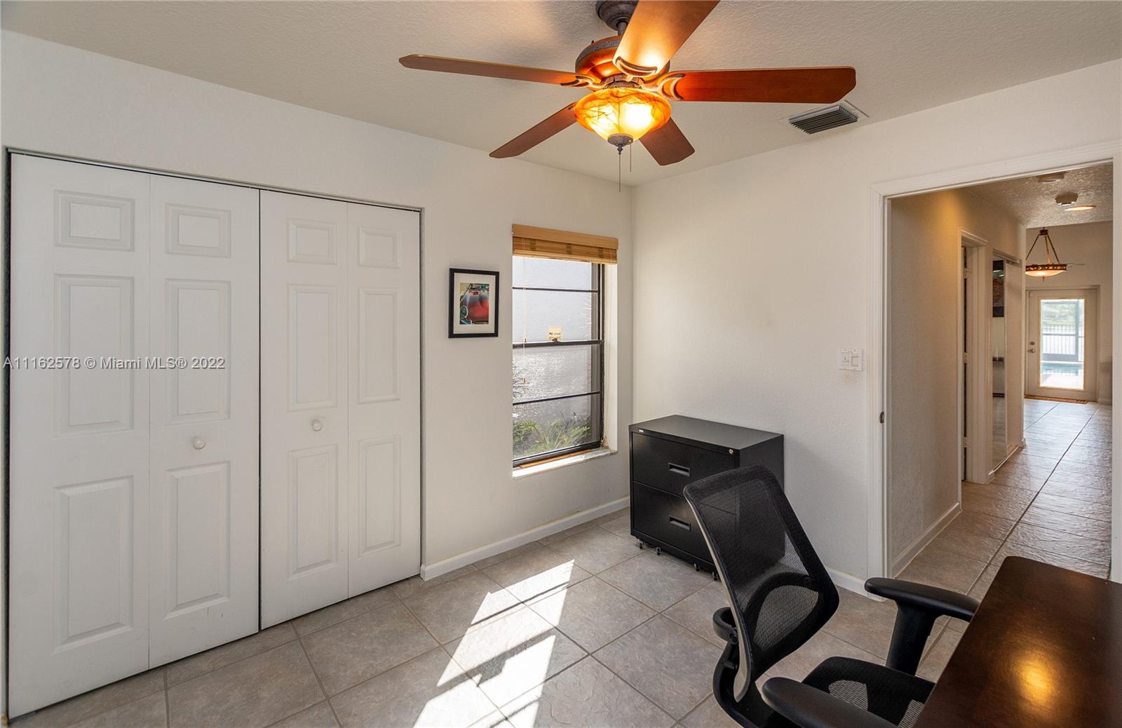11612 Quiet Waters Lane Boca Raton, FL 33428 - Photo 44 of 70 a view of a workspace with furniture and a window