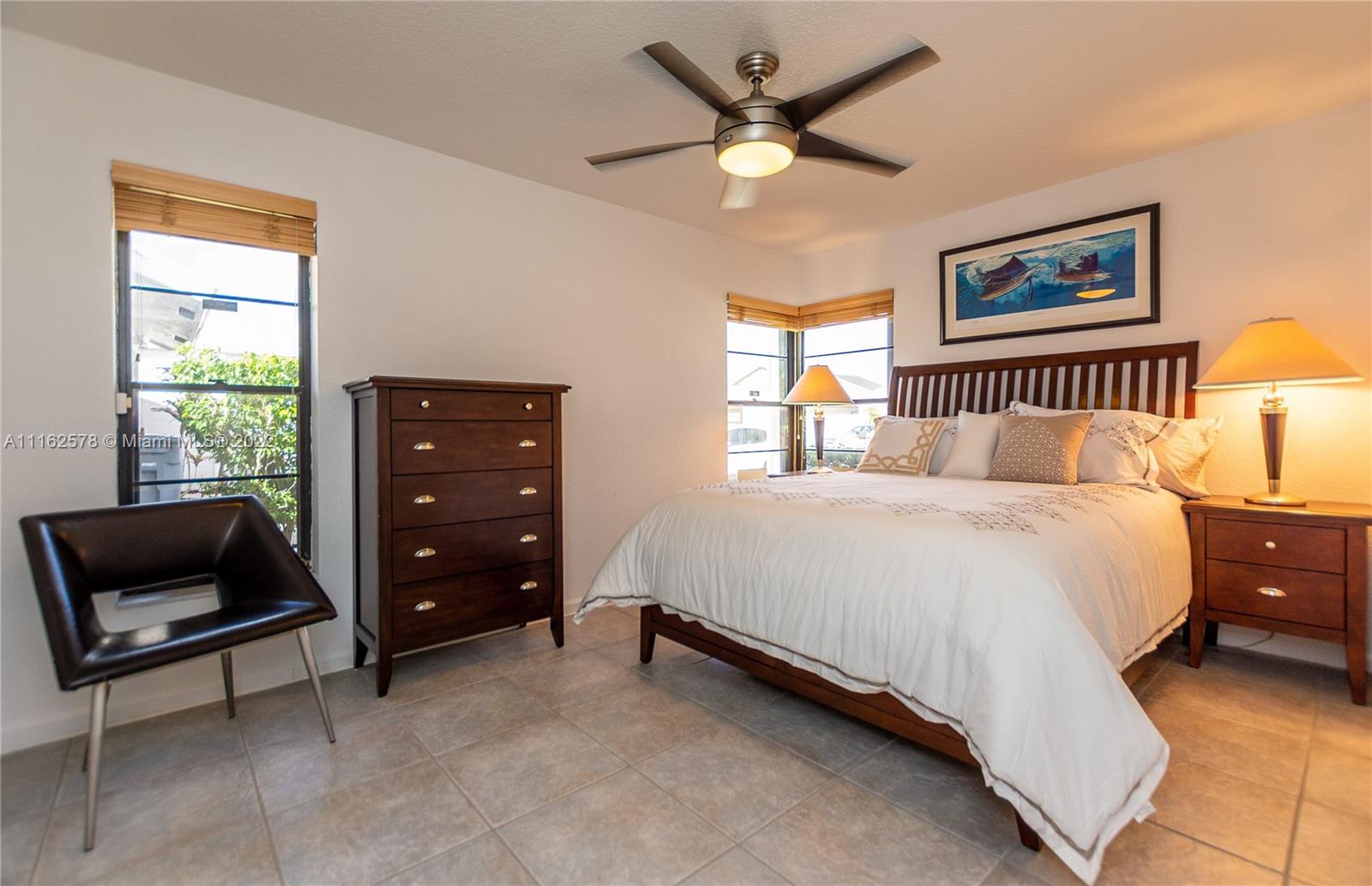 11612 Quiet Waters Lane Boca Raton, FL 33428 - Photo 46 of 70 a bedroom with a bed and a window