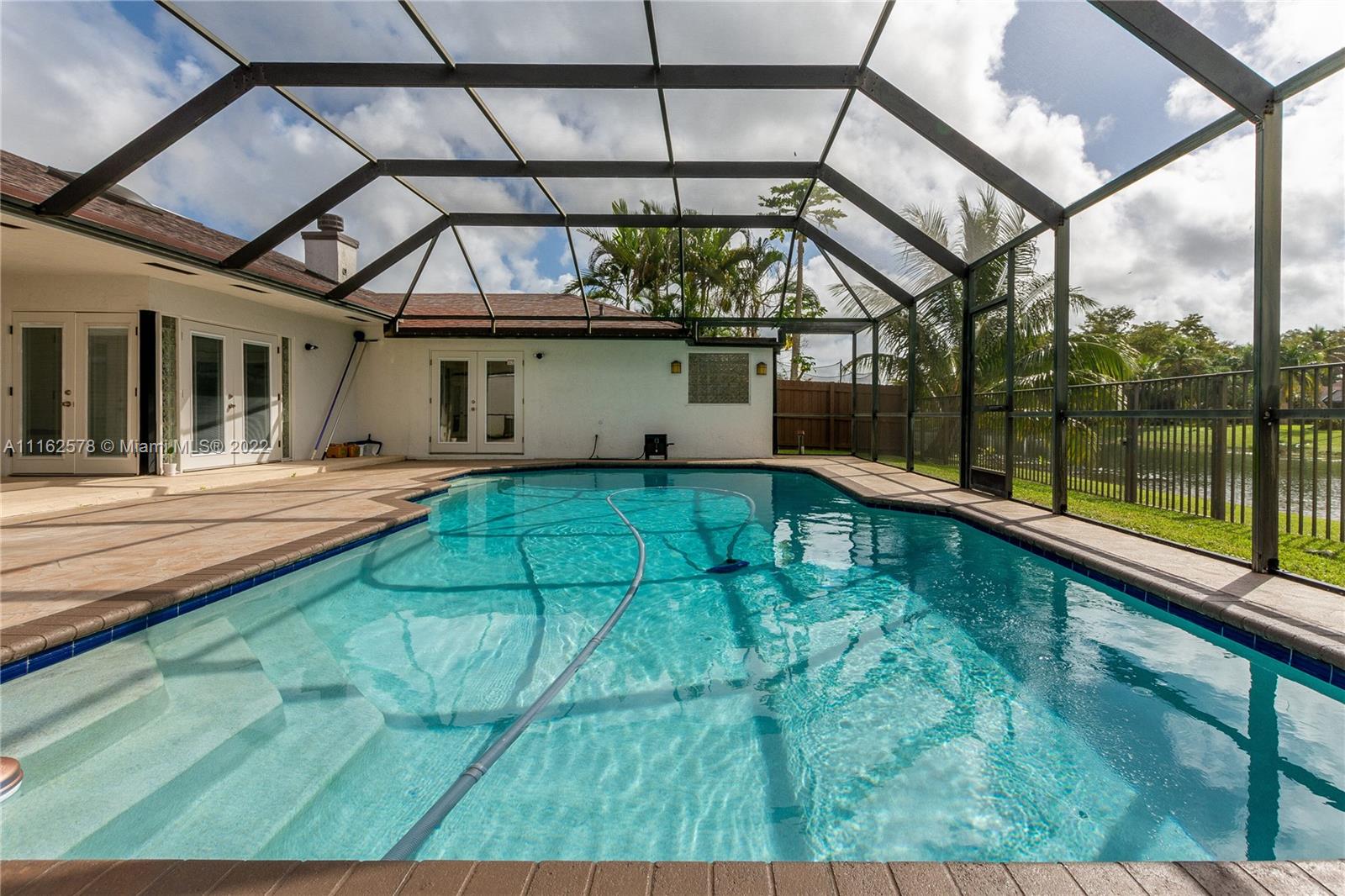 11612 Quiet Waters Lane Boca Raton, FL 33428 - Photo 55 of 70 a view of a swimming pool with a patio