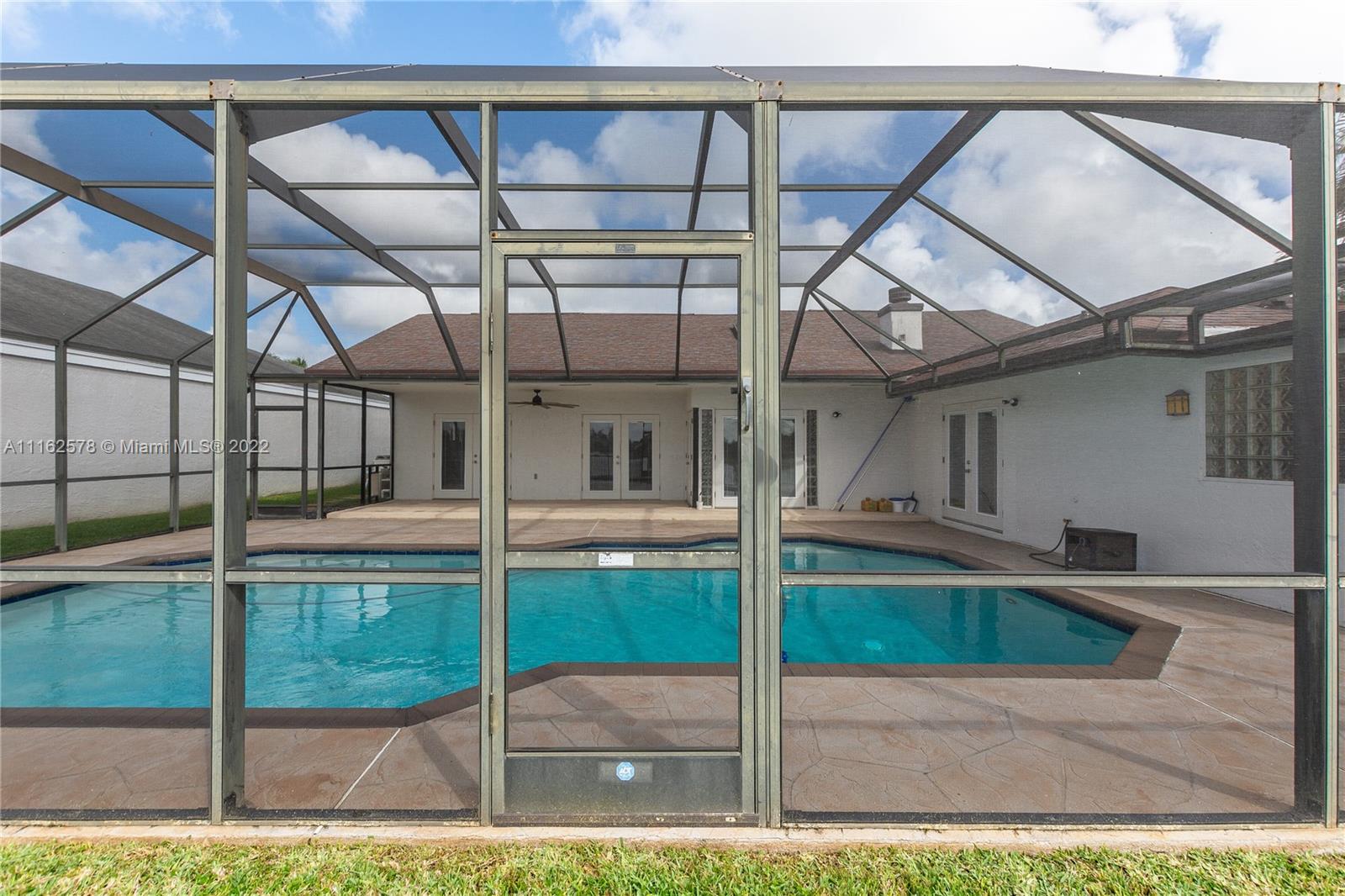 11612 Quiet Waters Lane Boca Raton, FL 33428 - Photo 58 of 70 a swimming pool with yard in the background