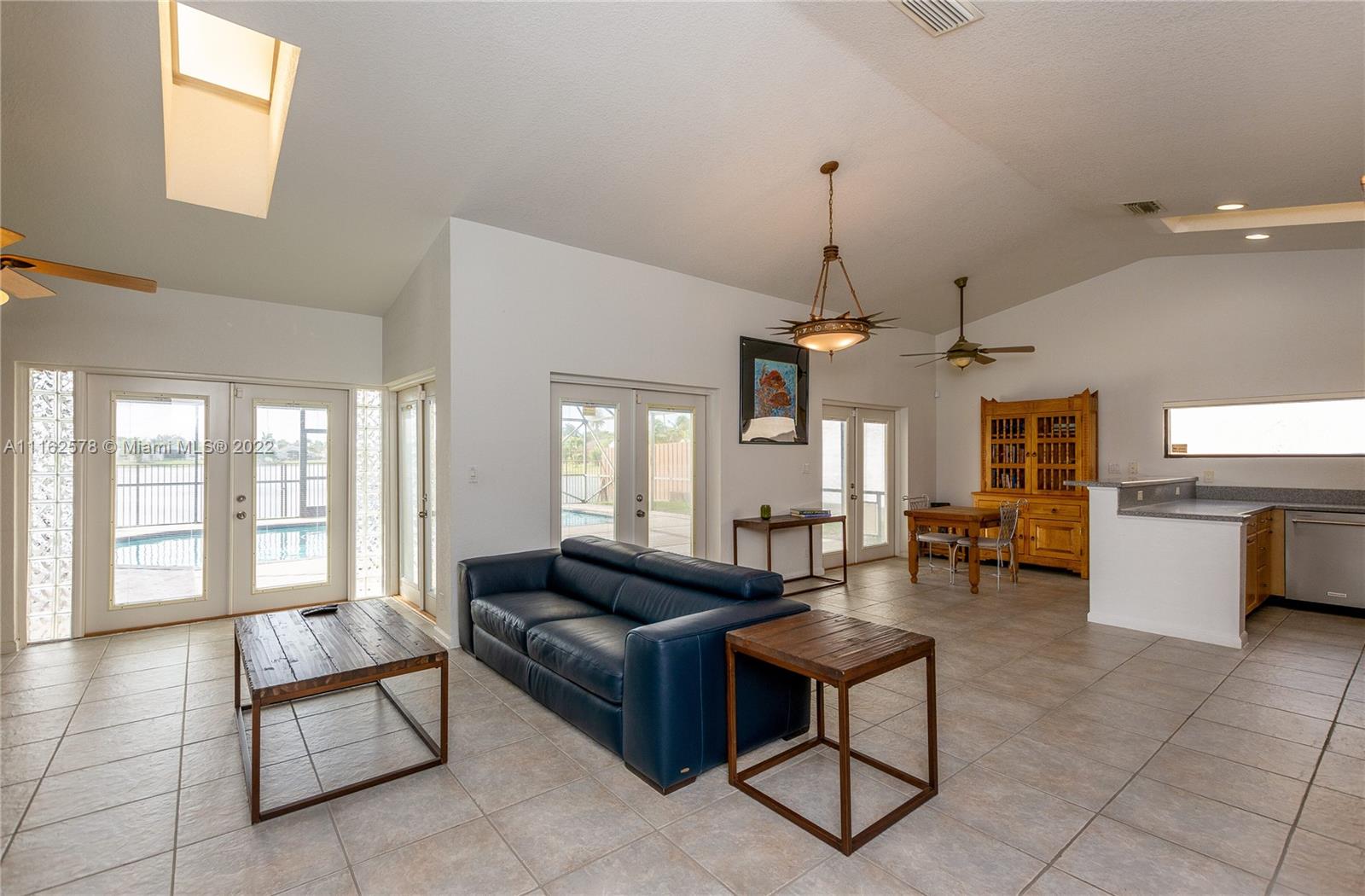 11612 Quiet Waters Lane Boca Raton, FL 33428 - Photo 6 of 70 a living room with furniture and a chandelier