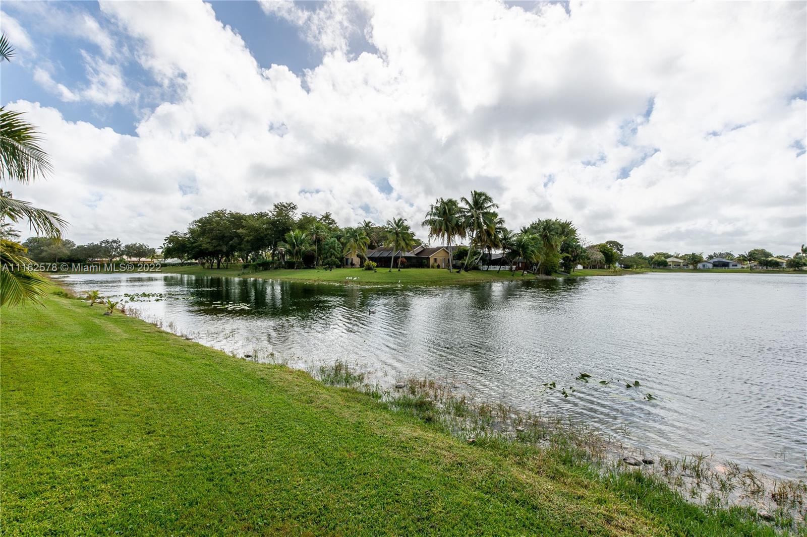 11612 Quiet Waters Lane Boca Raton, FL 33428 - Photo 67 of 70 a view of a lake with houses in the back