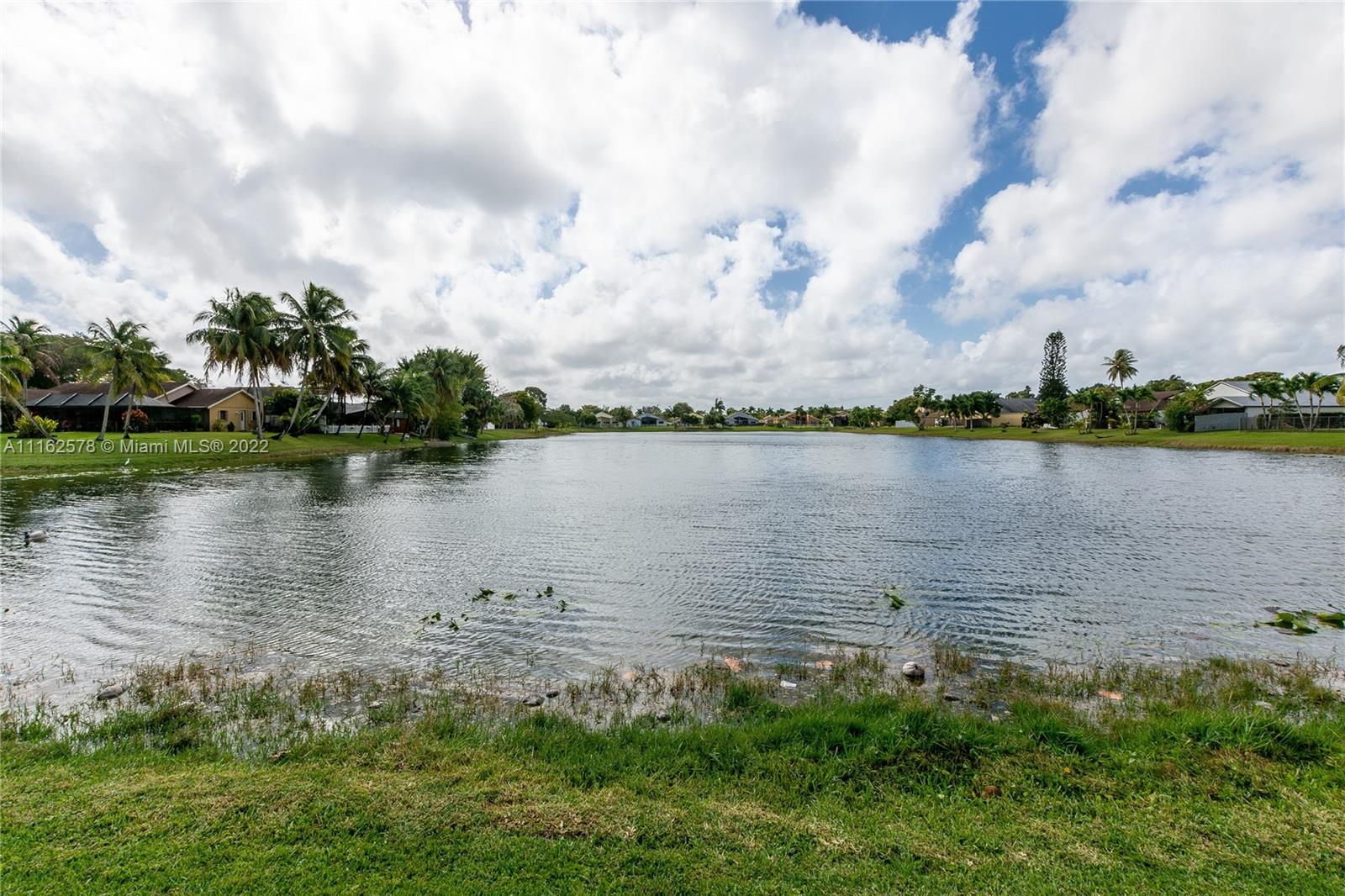 11612 Quiet Waters Lane Boca Raton, FL 33428 - Photo 69 of 70 a view of a lake with houses in the back