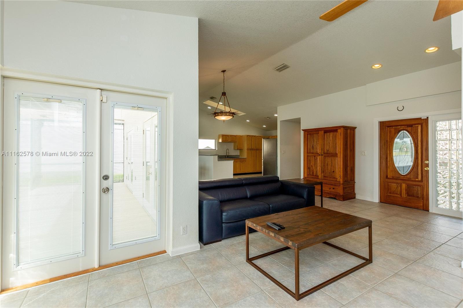 11612 Quiet Waters Lane Boca Raton, FL 33428 - Photo 7 of 70 a living room with furniture and large windows