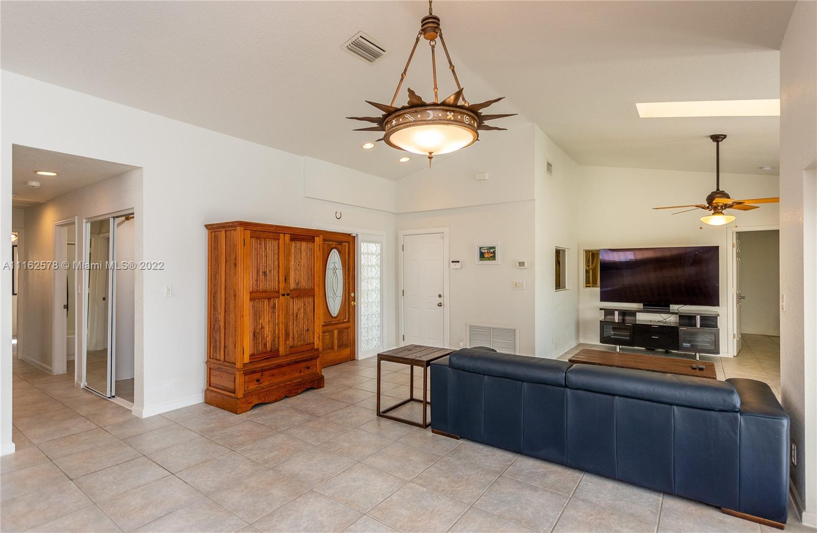 11612 Quiet Waters Lane Boca Raton, FL 33428 - Photo 9 of 70 a living room with furniture and a flat screen tv