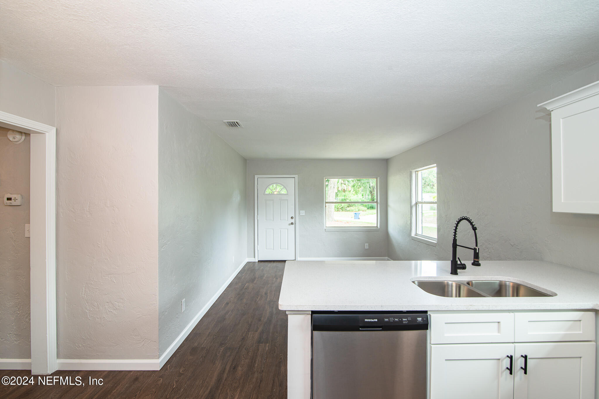 1702 King Arthur Road Jacksonville, FL 32211 - Photo 12 of 24 a kitchen with a sink and cabinets