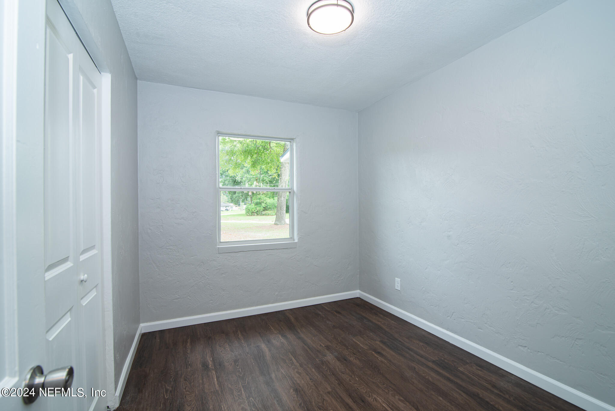 1702 King Arthur Road Jacksonville, FL 32211 - Photo 15 of 24 a view of an empty room with wooden floor and a window