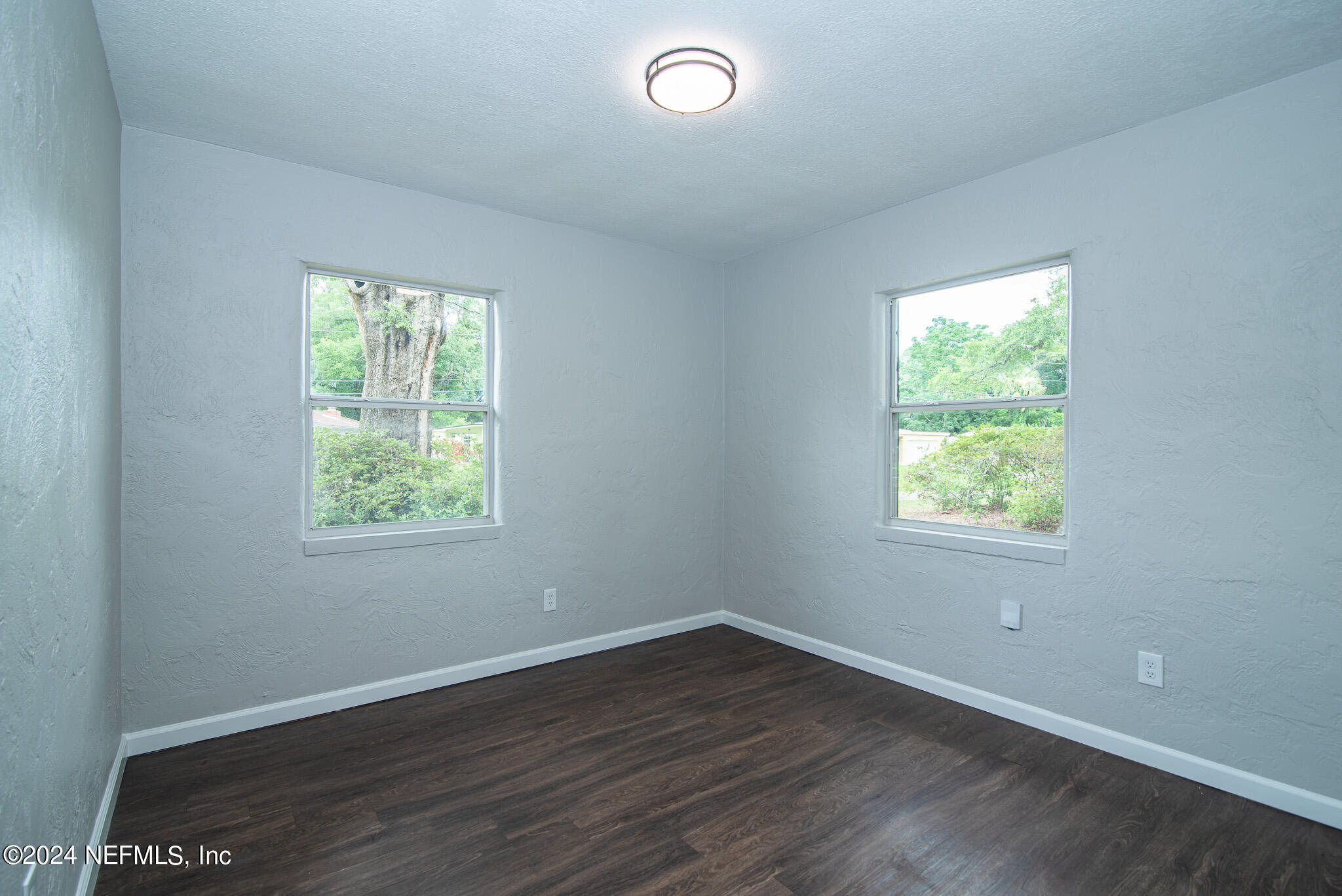 1702 King Arthur Road Jacksonville, FL 32211 - Photo 16 of 24 an empty room with wooden floor and windows