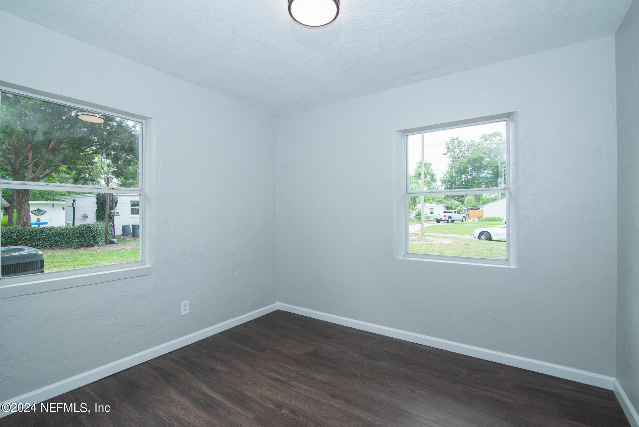 1702 King Arthur Road Jacksonville, FL 32211 - Photo 17 of 24 an empty room with wooden floor and windows