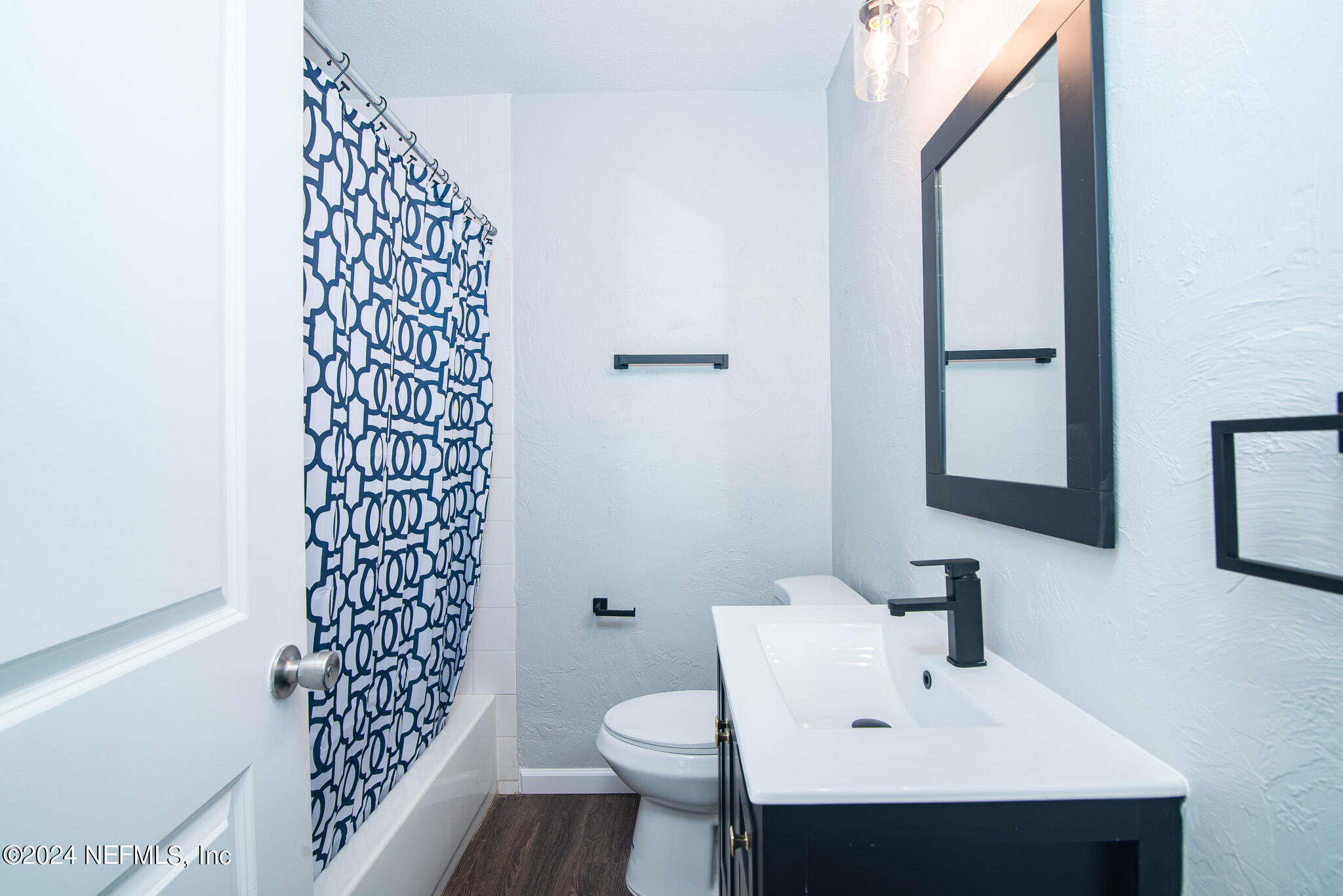 1702 King Arthur Road Jacksonville, FL 32211 - Photo 18 of 24 a bathroom with a sink toilet and mirror