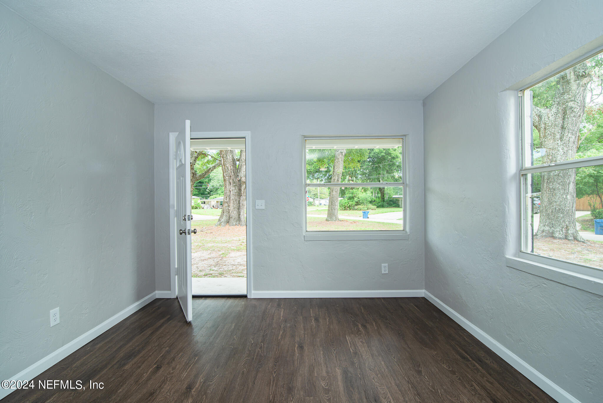 1702 King Arthur Road Jacksonville, FL 32211 - Photo 19 of 24 an empty room with wooden floor and windows