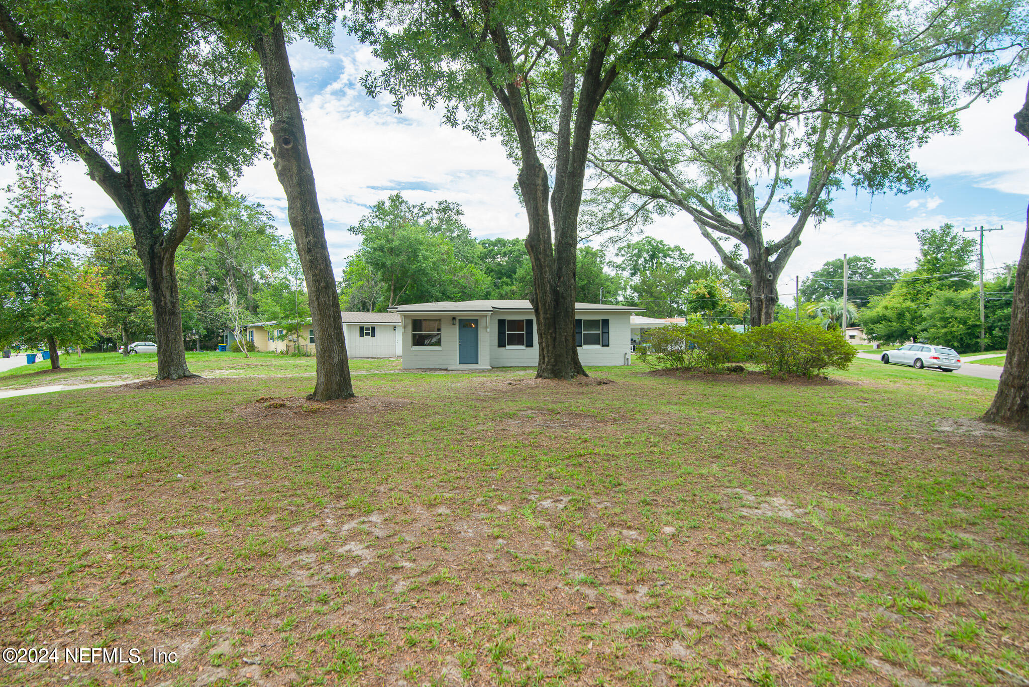 1702 King Arthur Road Jacksonville, FL 32211 - Photo 2 of 24 a view of backyard with tree and green space