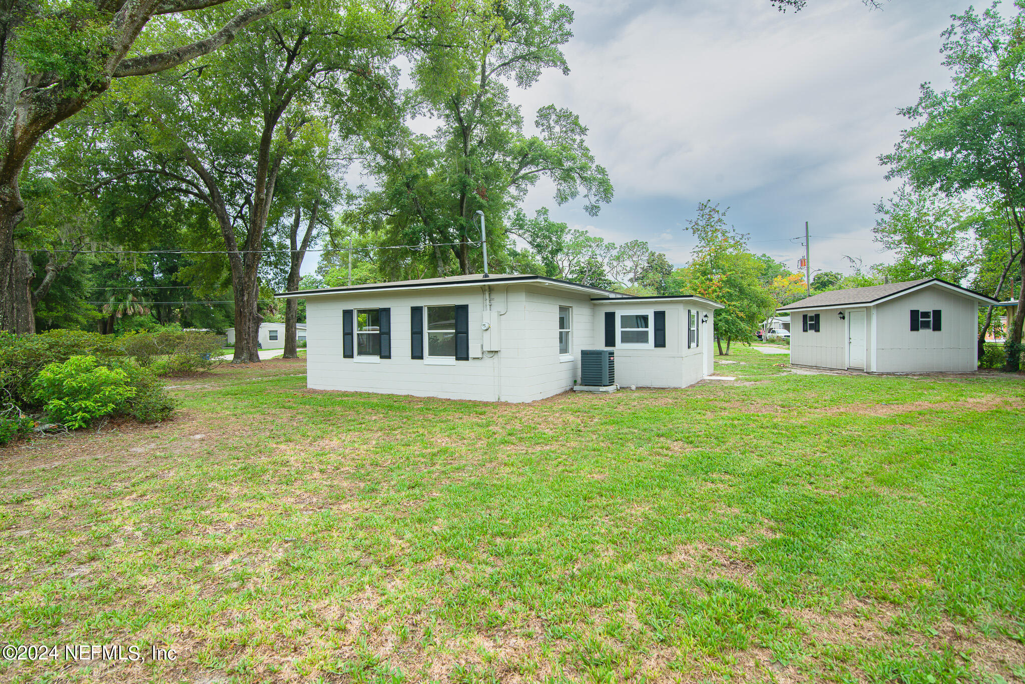 1702 King Arthur Road Jacksonville, FL 32211 - Photo 22 of 24 a front view of a house with a garden