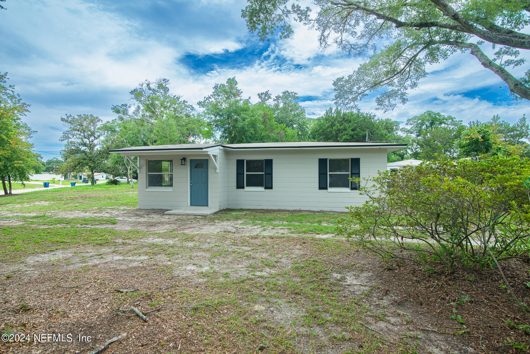 1702 King Arthur Road Jacksonville, FL 32211 - Photo 4 of 24 a view of a house with yard and a garden