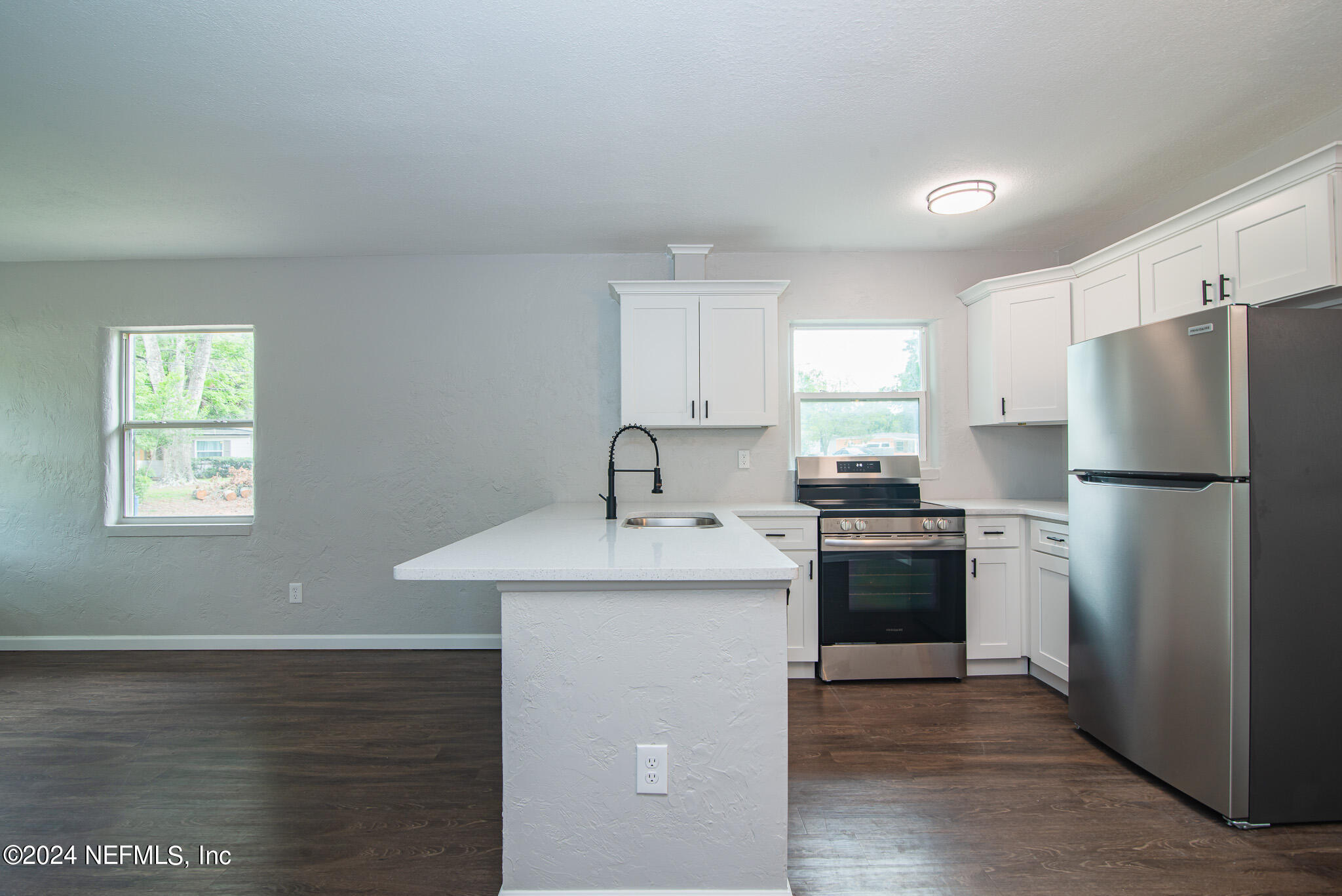 1702 King Arthur Road Jacksonville, FL 32211 - Photo 8 of 24 a kitchen with stainless steel appliances granite countertop a sink stove and refrigerator