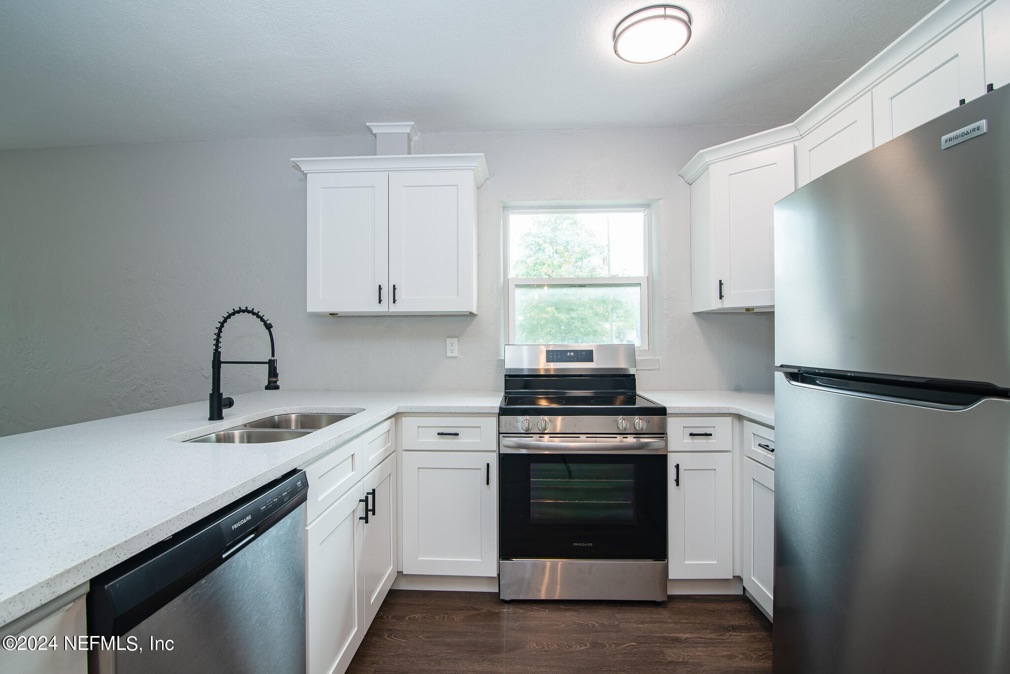 1702 King Arthur Road Jacksonville, FL 32211 - Photo 9 of 24 a kitchen with a refrigerator sink and cabinets