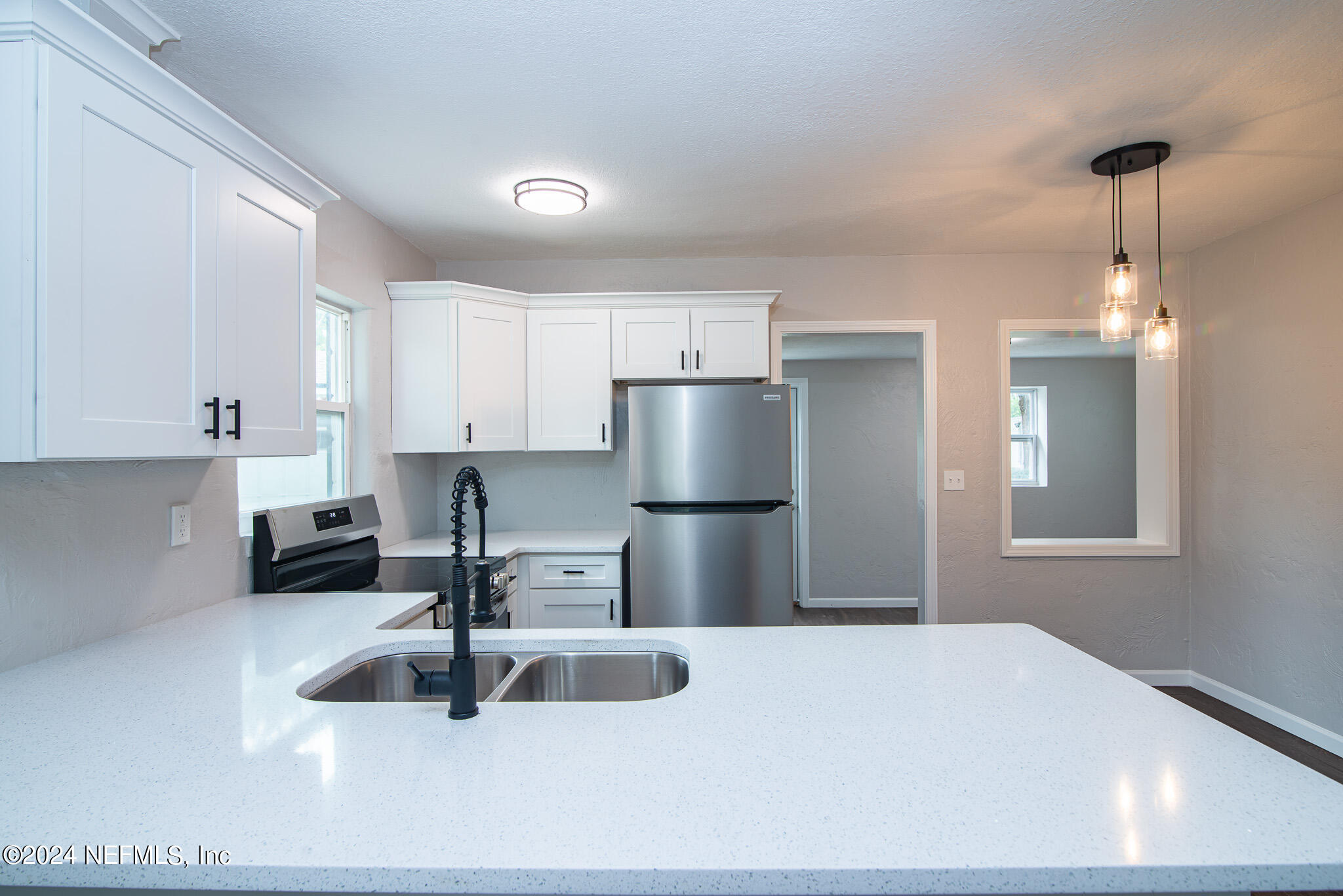 1702 King Arthur Road Jacksonville, FL 32211 - Photo 10 of 24 a kitchen with stainless steel appliances granite countertop a sink refrigerator and cabinets