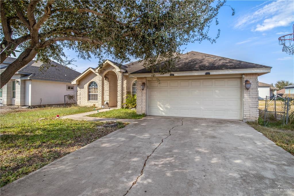 2509 Coma Street Hidalgo, TX 78557 - Photo 2 of 12 a front view of a house with a garden and yard
