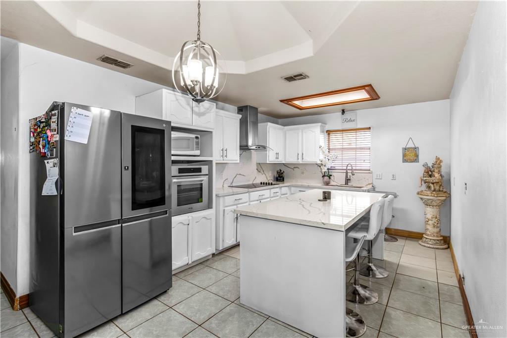 2509 Coma Street Hidalgo, TX 78557 - Photo 5 of 12 a kitchen with refrigerator cabinets and ceiling fan