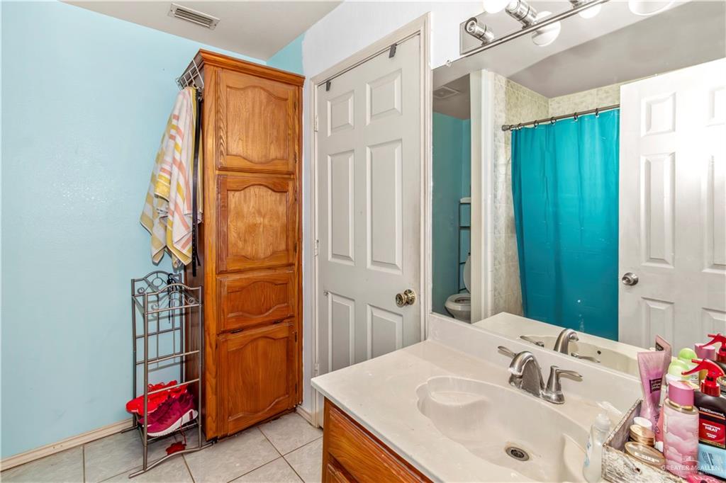 2509 Coma Street Hidalgo, TX 78557 - Photo 9 of 12 a bathroom with a sink and a mirror