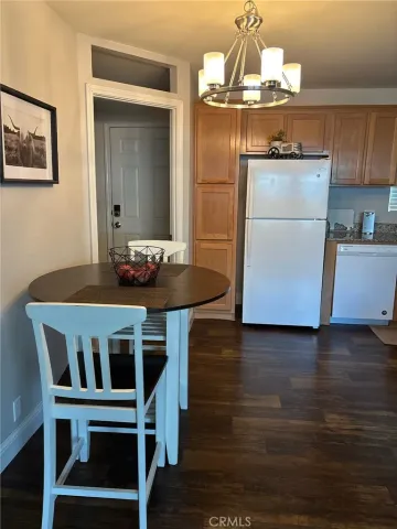 a kitchen with a table chairs and refrigerator