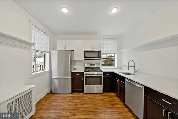 a kitchen with granite countertop stainless steel appliances and sink