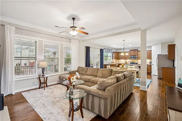 a living room with furniture and kitchen view